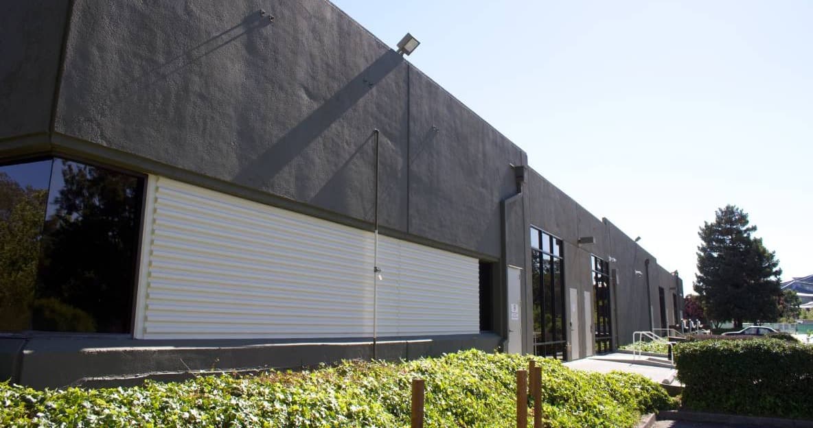 Repainted warehouse exterior with cream roll-up door, San Jose, CA